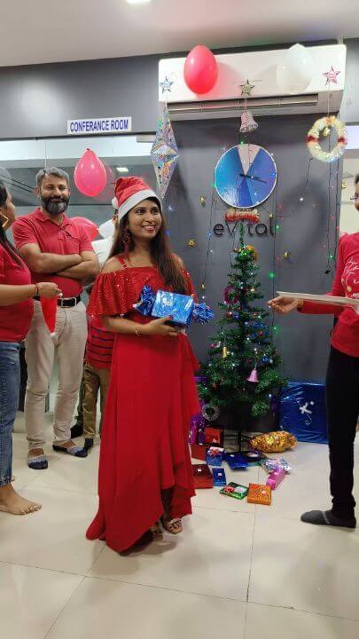 evitalrx pharmacy software employee sarita getting christmas gift at new year celebration party at evital office in ahmedabad