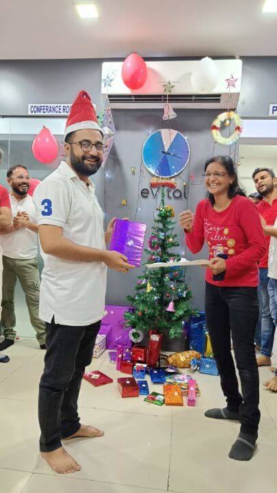 evitalrx pharmacy software employee hamid getting christmas gift at new year celebration party at evital office in ahmedabad